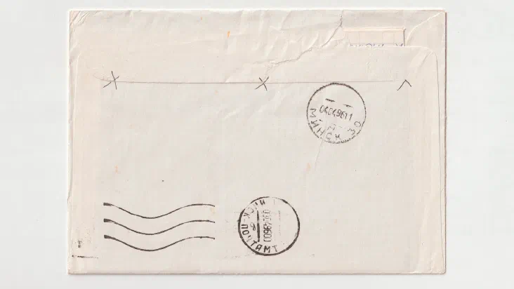 A rubber stamp resting on a stamped piece of paper