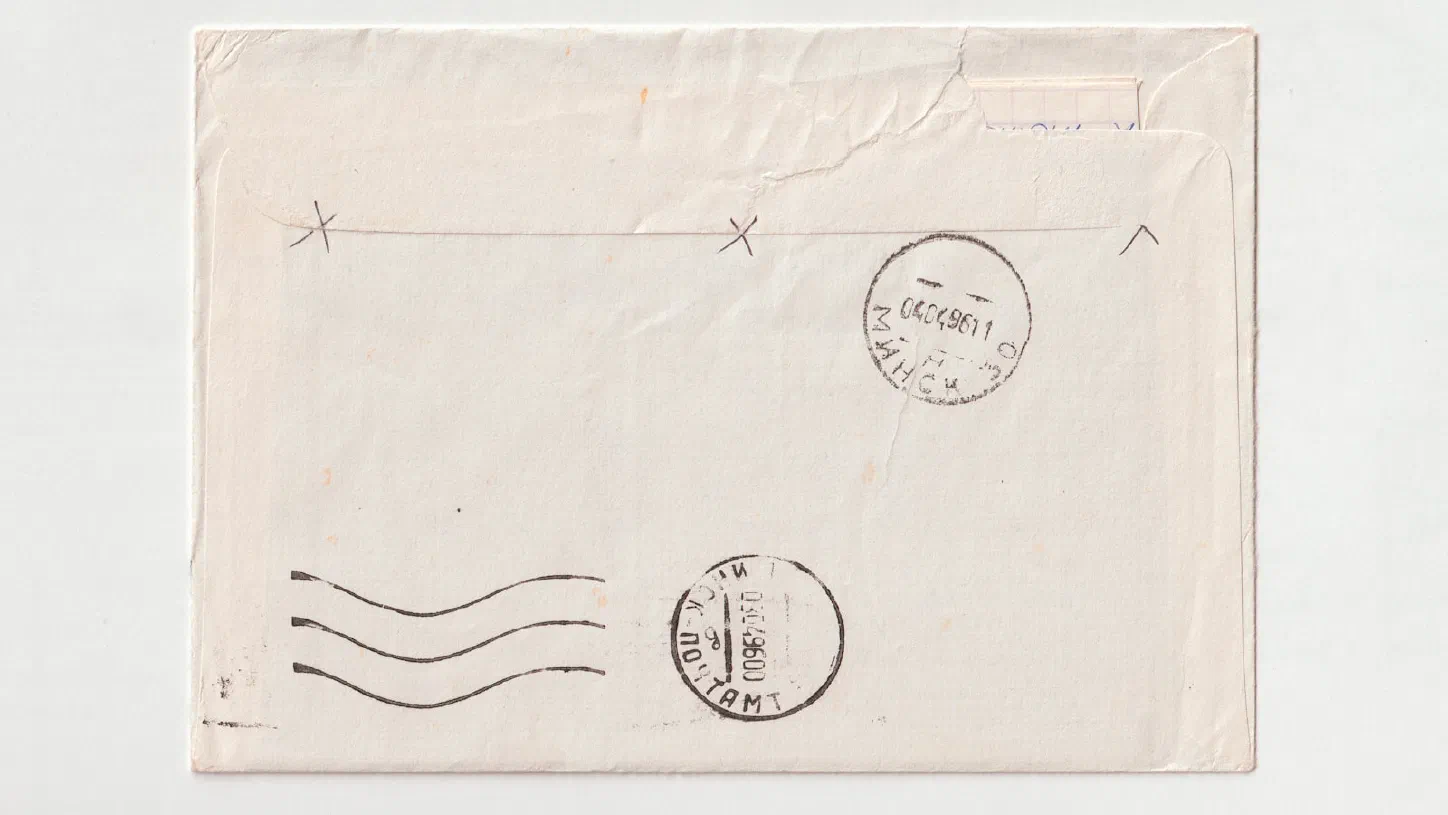 A rubber stamp resting on a stamped piece of paper