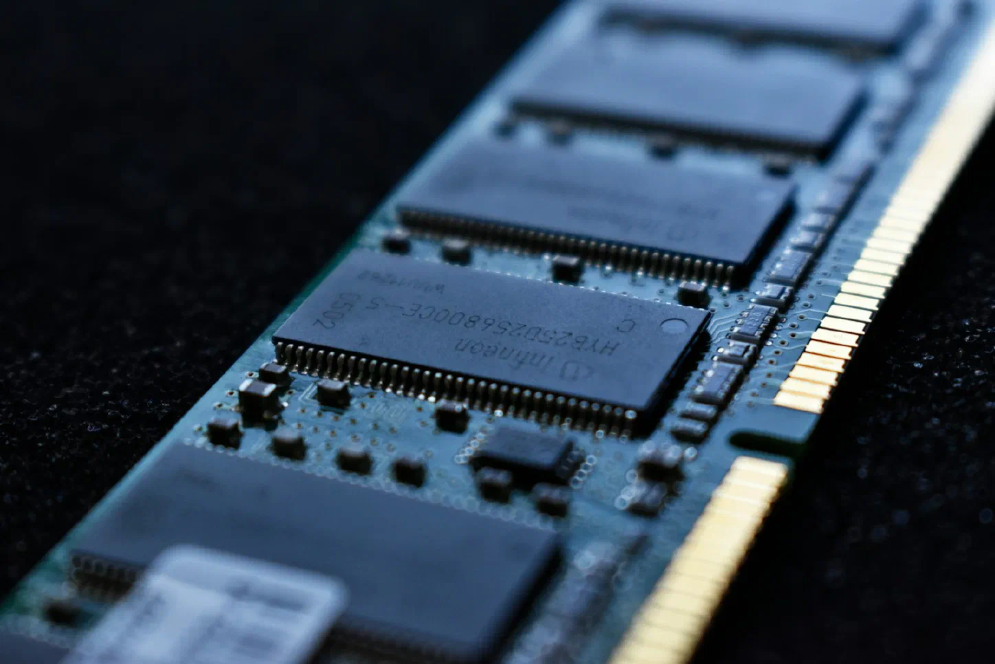 Extreme macro close-up of a computer RAM memory module's circuit board and chips