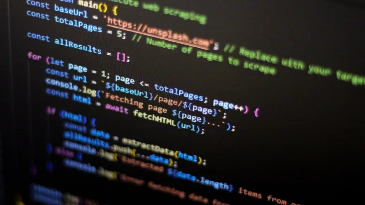 A close-up of a computer screen displaying colorful lines of programming code