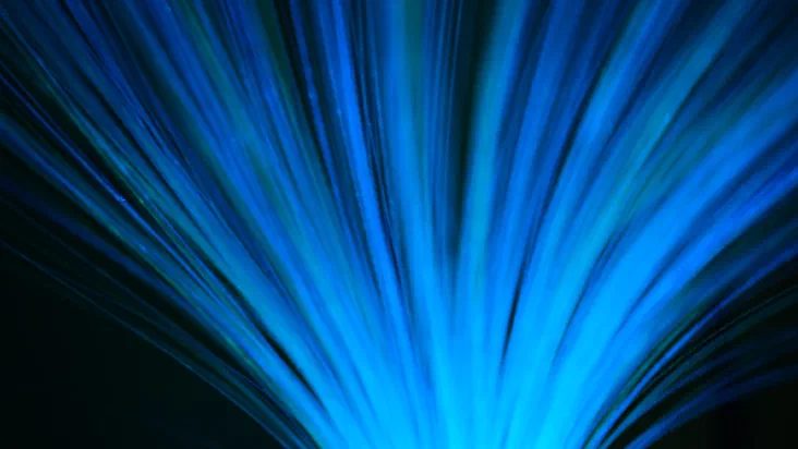 Blue fiber optic cables radiating outward with glowing light traveling through them