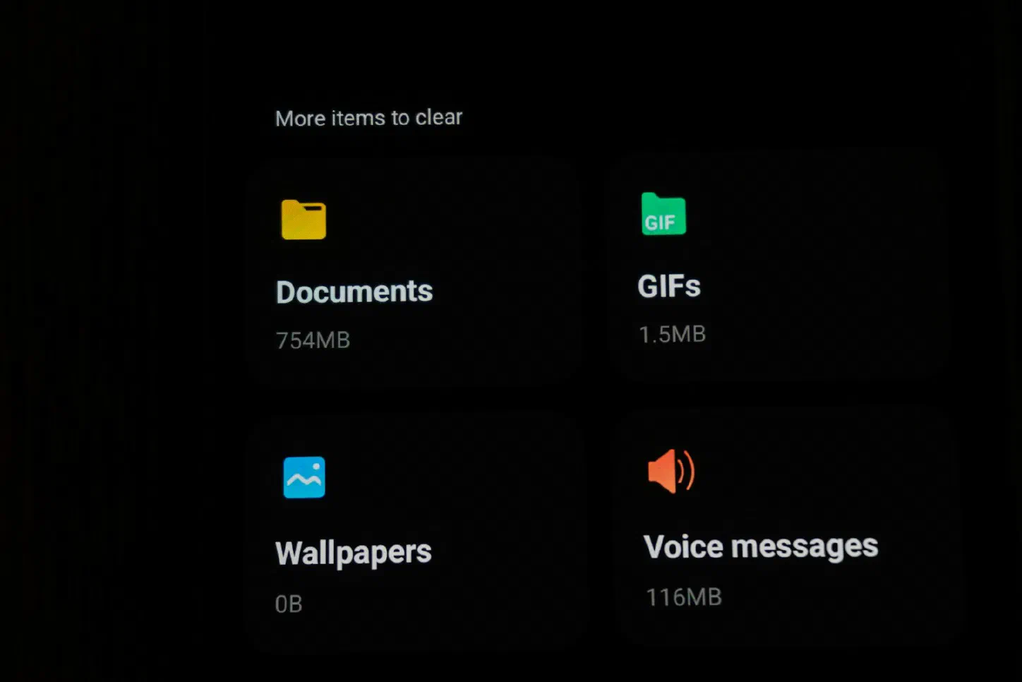 Phone storage screen listing Documents, GIFs, Wallpapers, and Voice messages with their file sizes