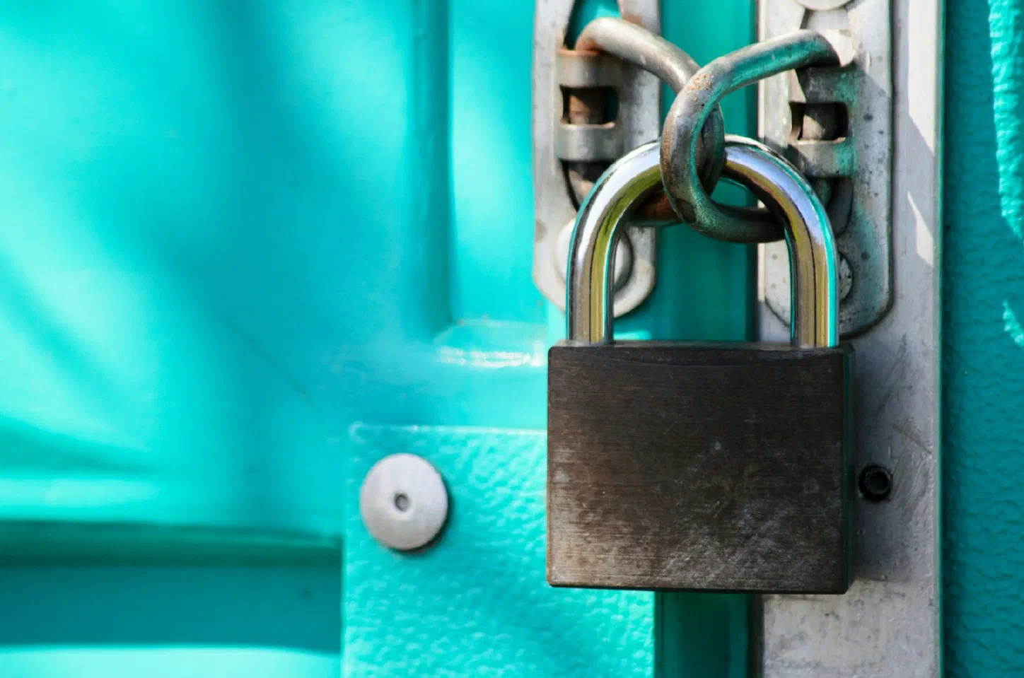 A close-up of a padlock securing a door