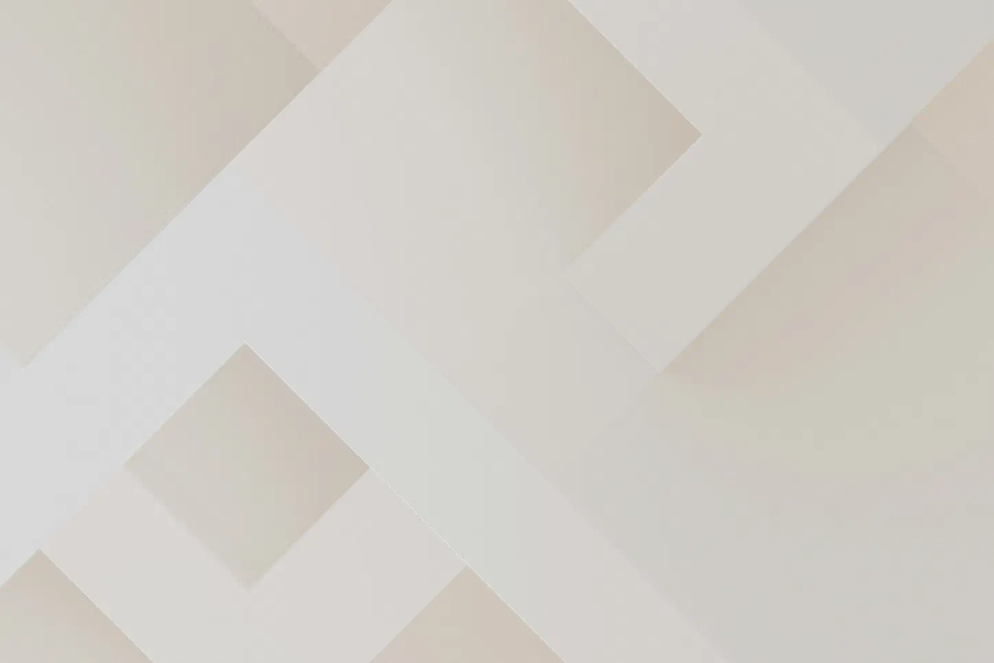 Abstract minimalist composition of overlapping cream and beige geometric planes forming diagonal, arrow-like shapes